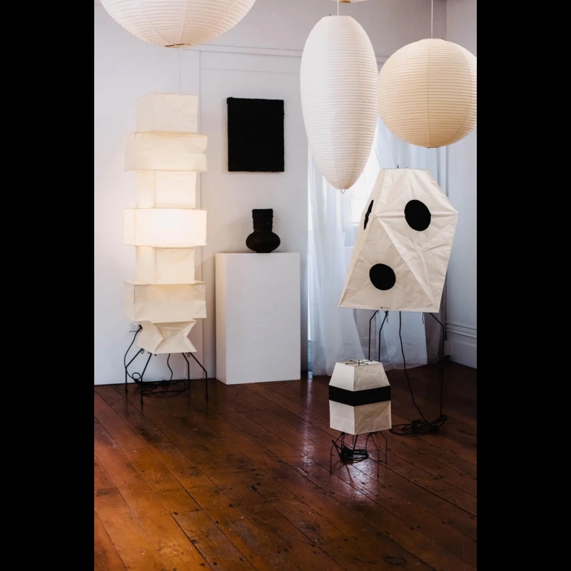 Floor Lamp: Faceted White Paper Shade, Washi Style, Slender Black Legs.