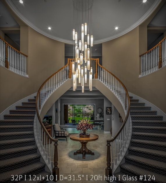 Long Chandelier Cascading White Petal Elements for High Ceilings.