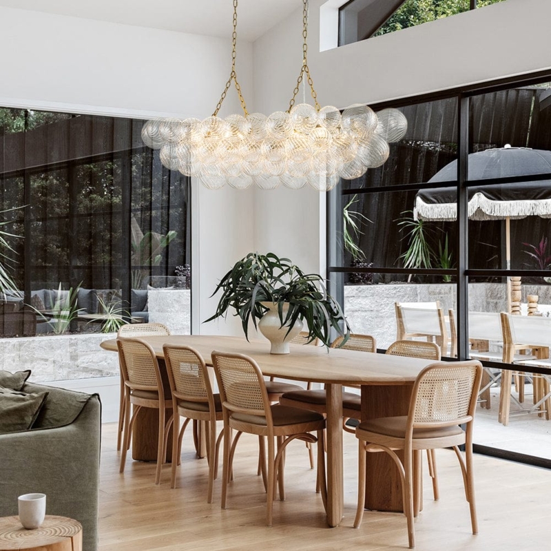 Polished Brass Linear Chandelier with Swirled Glass Globes.