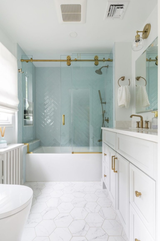 Airy Bathroom with Blue Herringbone Tile and Marble Hexagon Floor