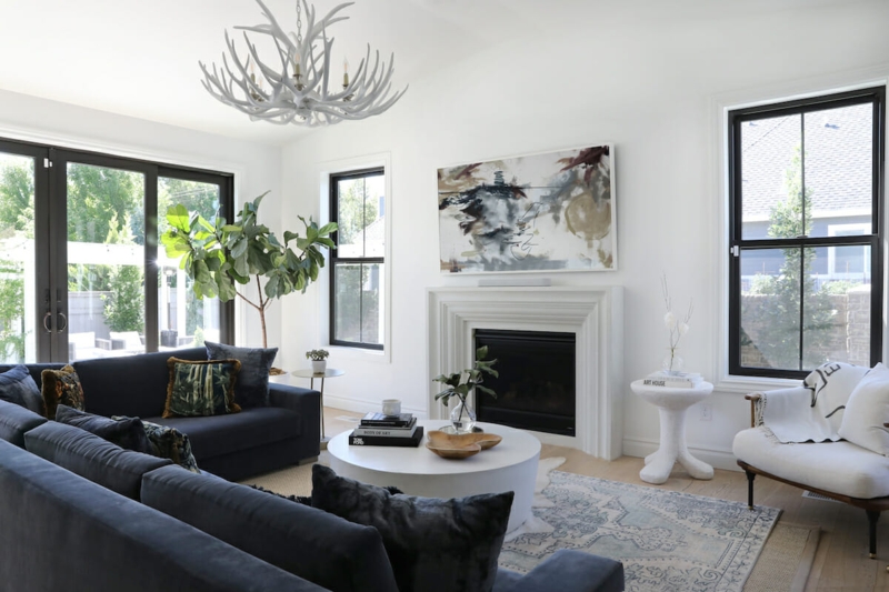 Airy Living Room Dark Blue Sectional Antler Chandelier Black Frames