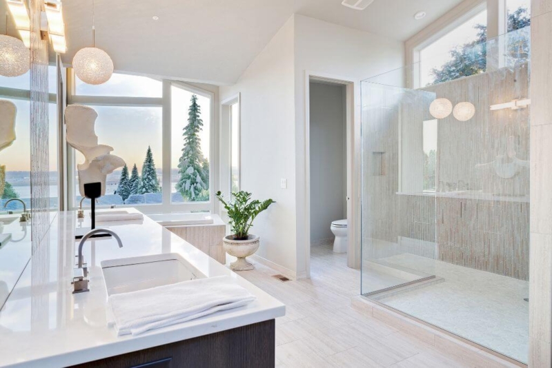 Airy Organic Bathroom with Floor-to-Ceiling Windows & Globe Pendants