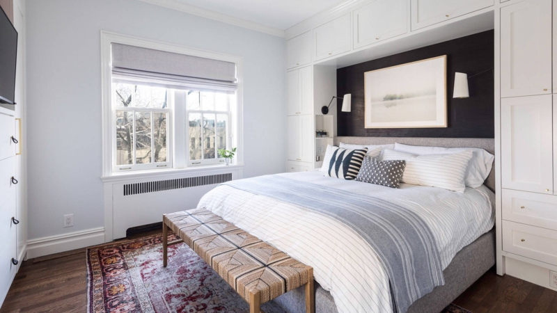 Alcove Bed Design with Cabinetry and Woven Bench at Foot of Bed