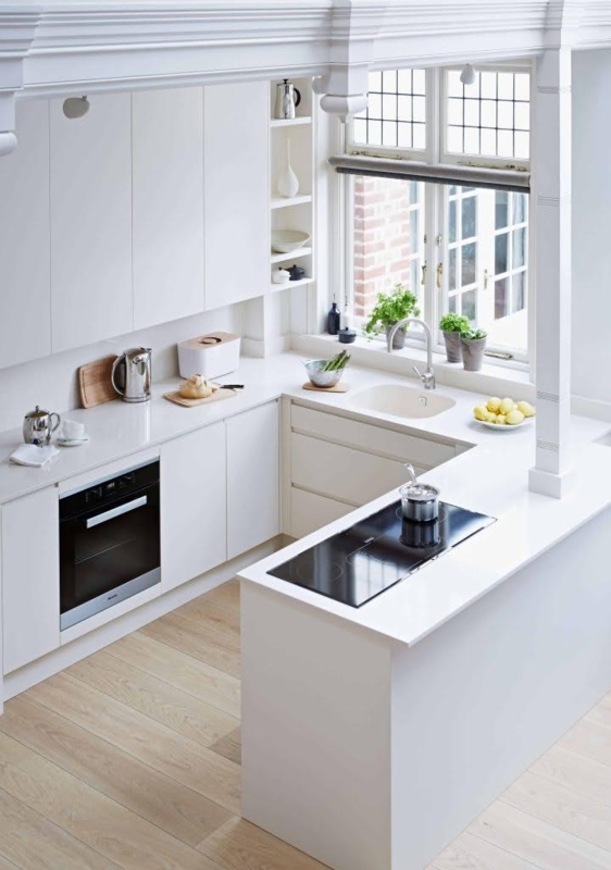 All-White Kitchen Layout with Ornate Ceiling Molding