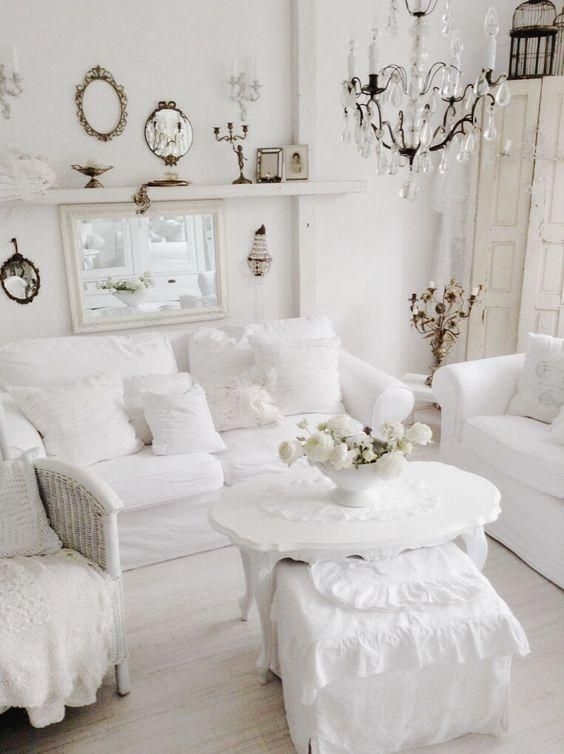All-White Living Room with Crystal Chandelier & Ornate Mirror Decor
