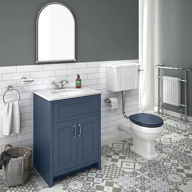 Arched Mirror over Navy Vanity with Patterned Floor Tiles