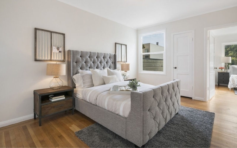 Area Rug in Grey Shag Texture grounded by Tufted Wingback Bed.