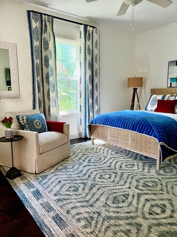 Area Rug in Navy Geometric Pattern with Woven Bed Frame.