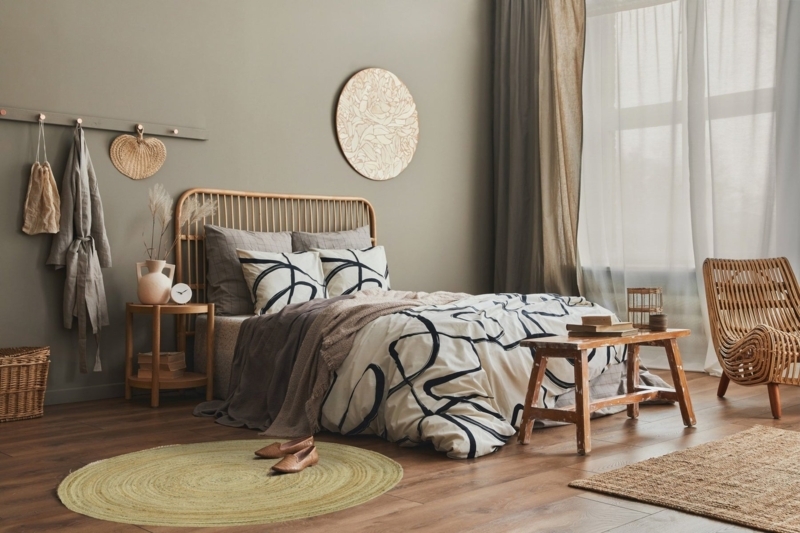Area Rug: Round Braided Jute in Boho Bedroom with Olive Green Walls.