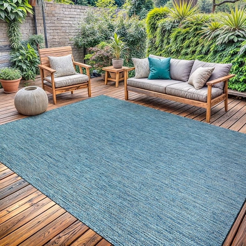 Area Rug: Vibrant Aqua Hue, Weather Resistant, Modern Solid, Washable.