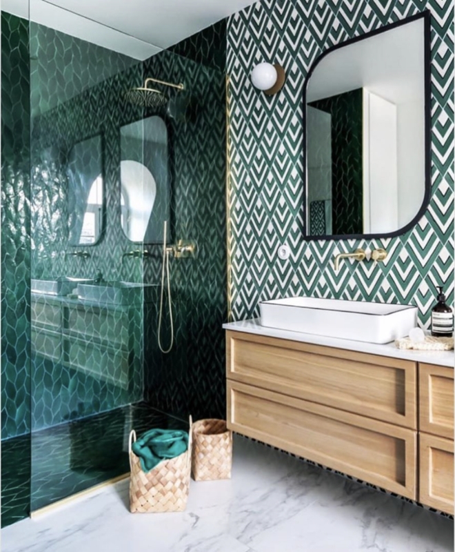 Art Deco Bathroom with Bold Green Chevron Tile and Arched Black Mirror