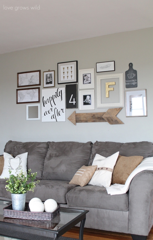 Asymmetrical Gallery Wall Above Sofa Featuring Rustic Wooden Arrow Decor
