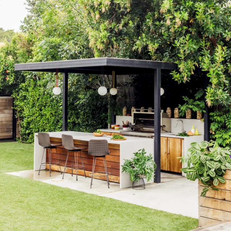 Backyard Island with Waterfall Counter and Black Pavilion Structure