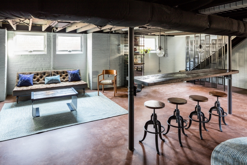 Bar Stools in Lounge with Stained Rust Concrete Basement Floors