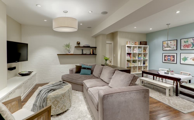 Basement Craft Room and Lounge Zoning with White Brick Accent Wall