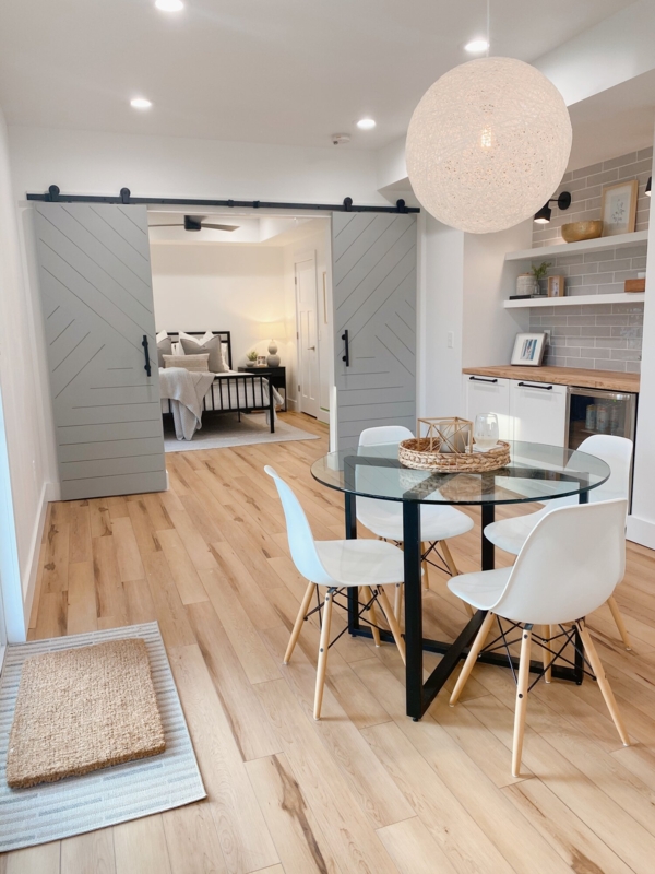Basement Dining Set with Round Glass Table and Geometric Barn Doors