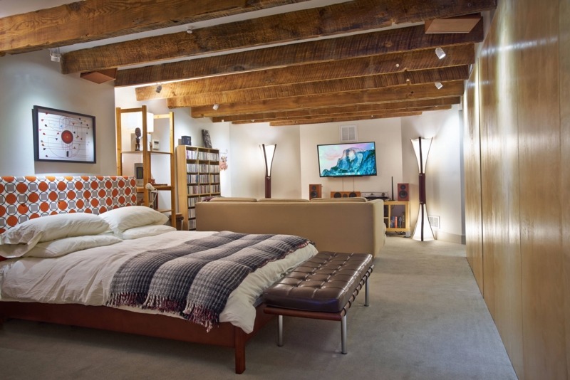 Basement Studio Apartment with Exposed Ceiling Beams and Multi-Zone Layout