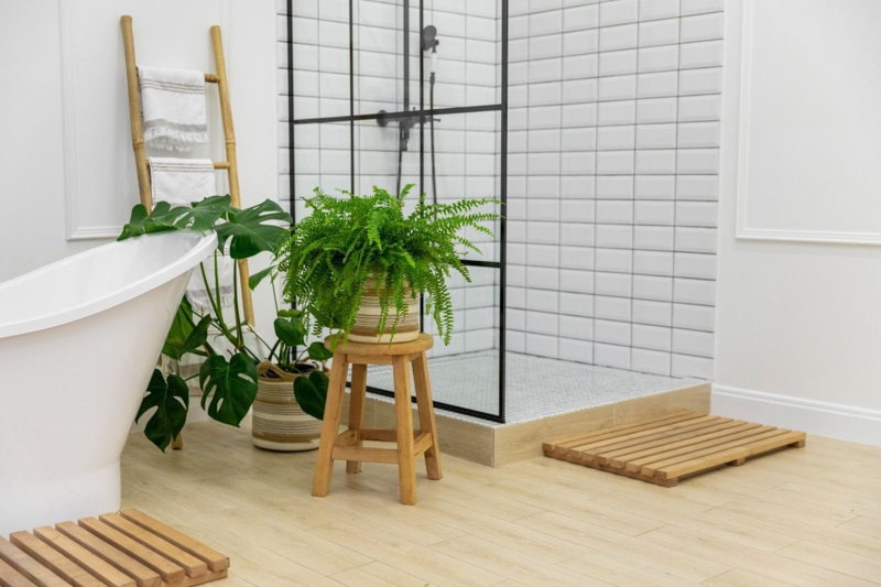 Bathroom Design: Wood-Toned Vinyl Flooring and Black-Framed Glass Shower