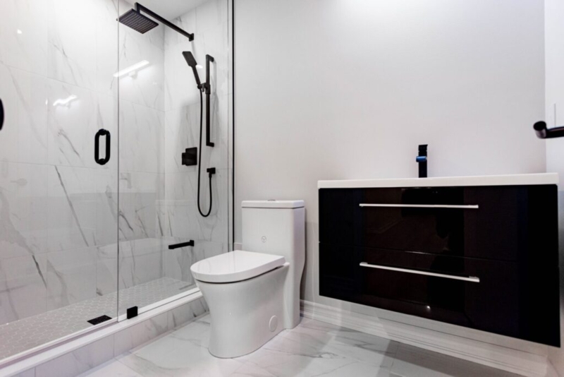 Bathroom featuring Glossy Floating Vanity Design and Marble Look Tile