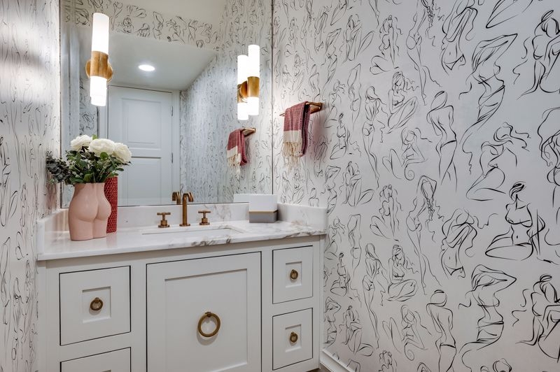 Bathroom Vanity with Figure Line Art Wallpaper and Gold Hardware