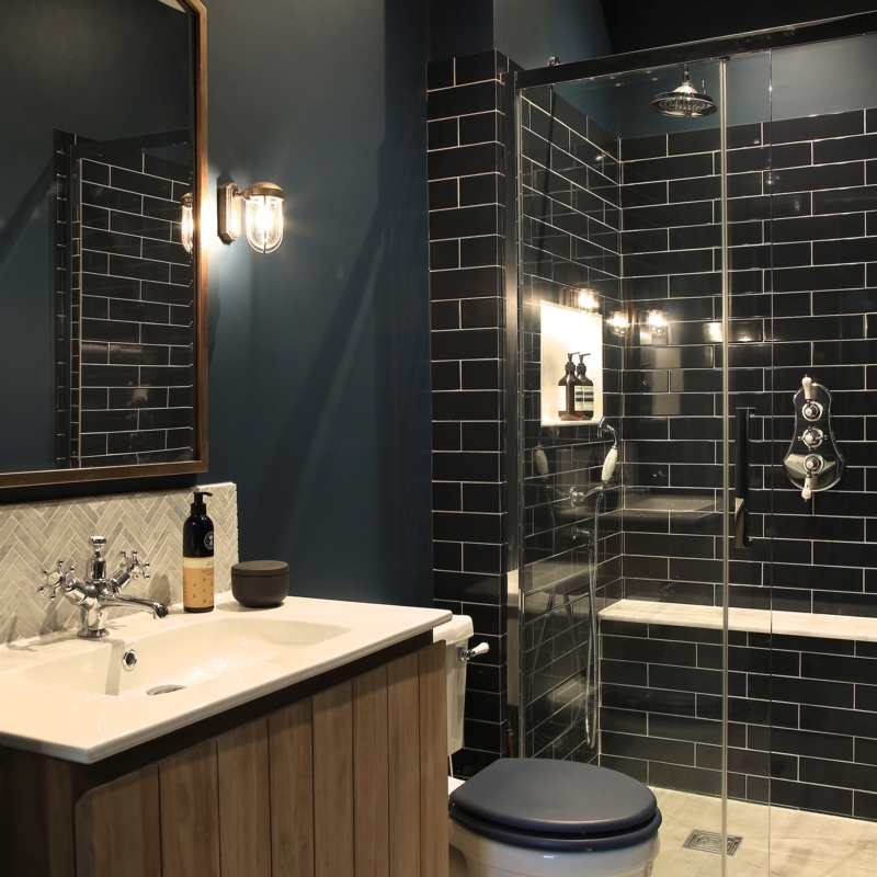 Bathroom Vanity with Glossy Black Subway Tiles and Navy Walls
