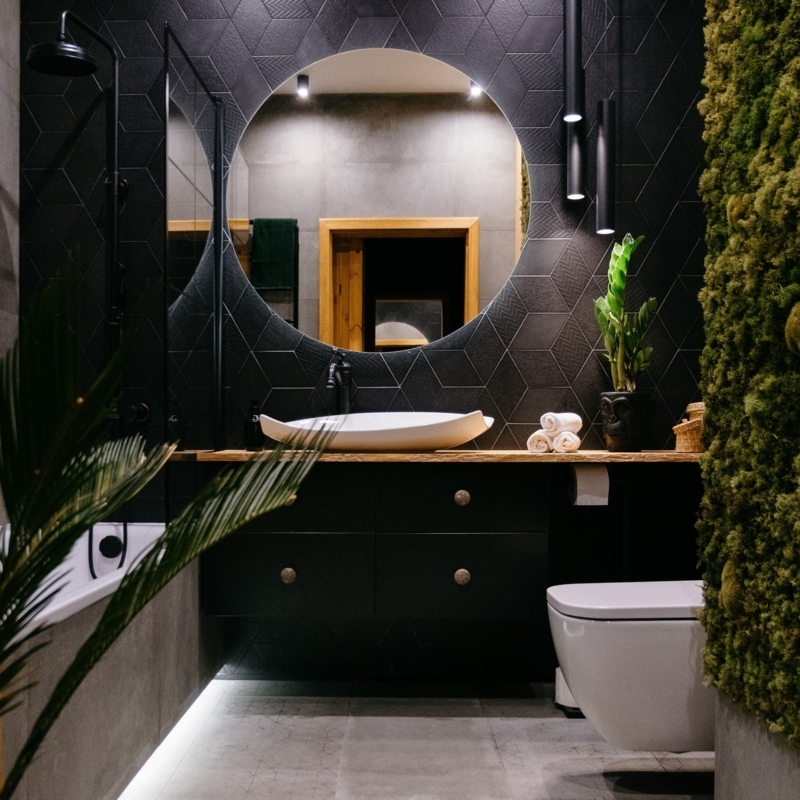 Bathroom Vanity with Moss Wall and Geometric Black Tiles