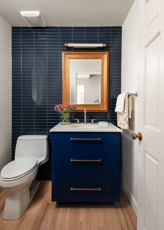 Bathroom Vanity with Navy Blue Vertical Stack Bond Tile Accent Wall