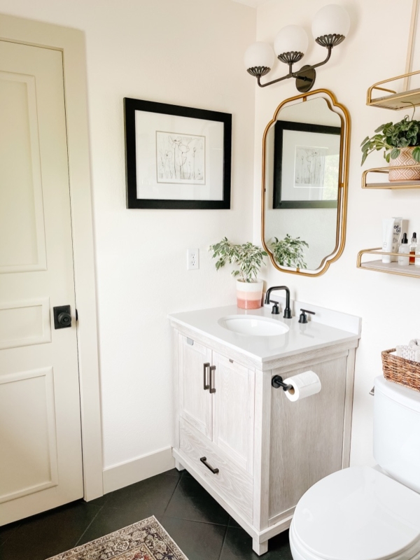 Bathroom Vanity with Scalloped Gold Mirror and Black Fixtures