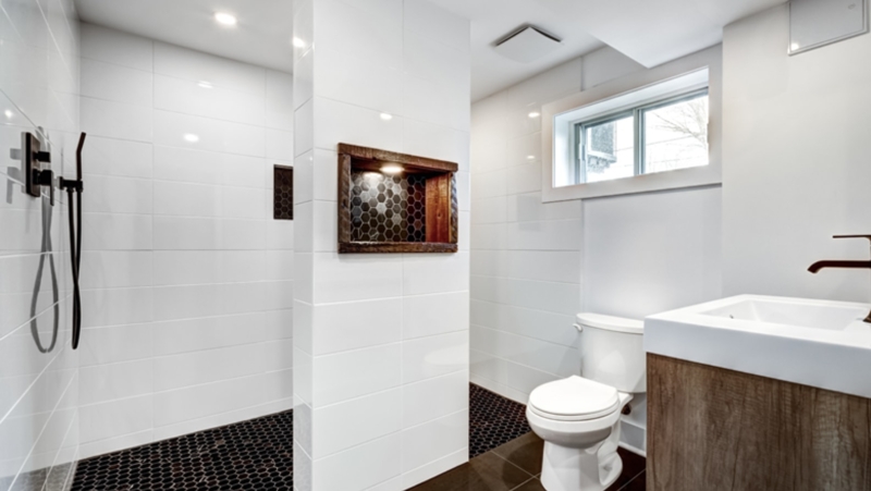 Bathroom with Black Penny Tile Floor and Wood Framed Wall Niche