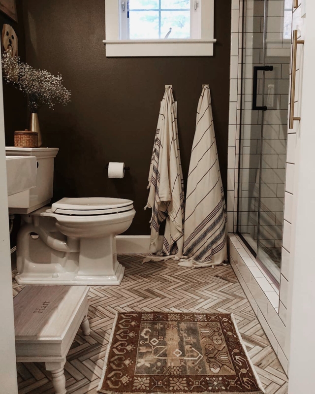 Bathroom with Dark Brown Walls and Herringbone Tile Floor Design