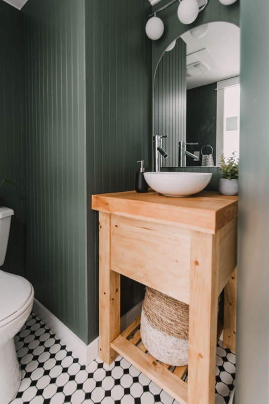 Bathroom with Green Vertical Paneling, Light Wood Vanity and Vessel Sink