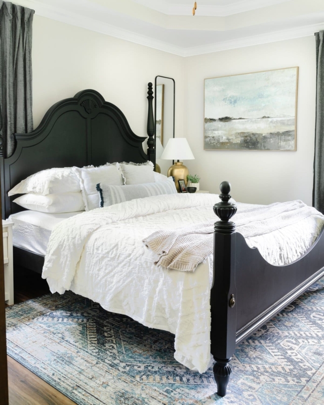 Bed Black Arched Headboard Blue Patterned Rug Textured White Bedding