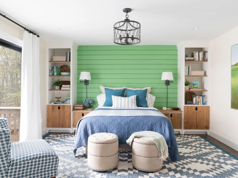 Bed Flanked by Integrated Bookcases and Vibrant Green Shiplap Accent Wall
