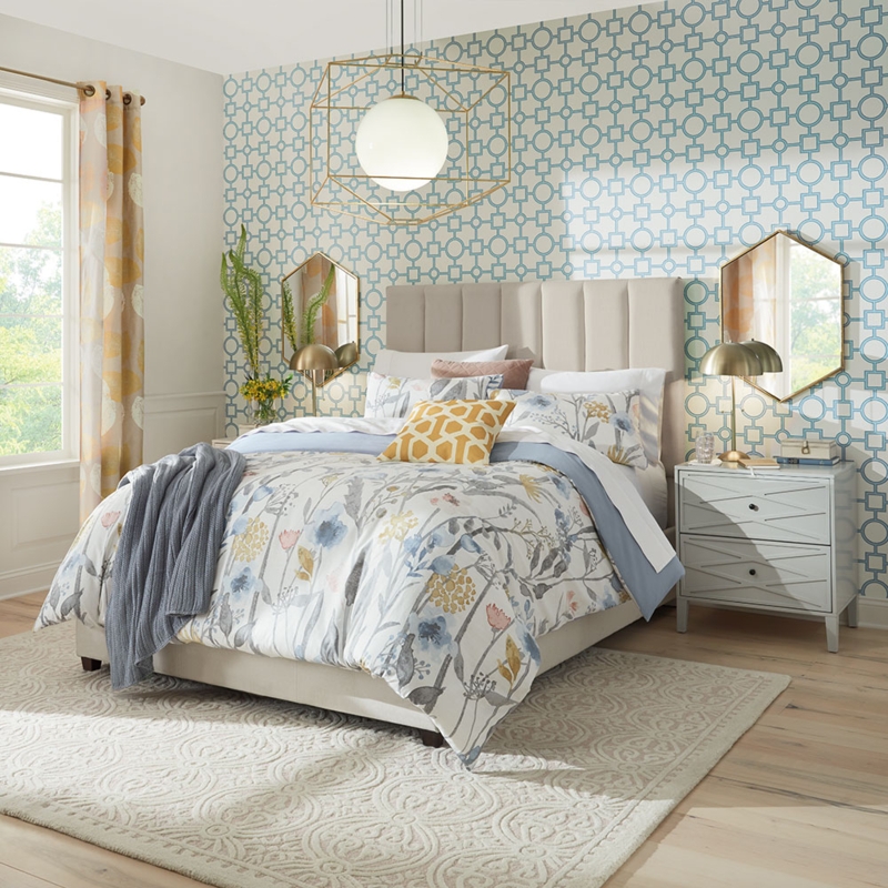 Bed in Bright Transitional Bedroom with Gold Hexagonal Mirrors