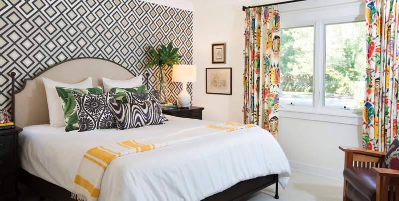 Bed in Eclectic Maximalist Bedroom featuring Face Pattern Curtains