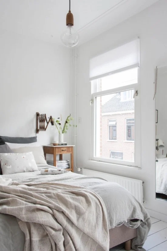 Bed with Accordion Wall Lamp and White Painted Floors