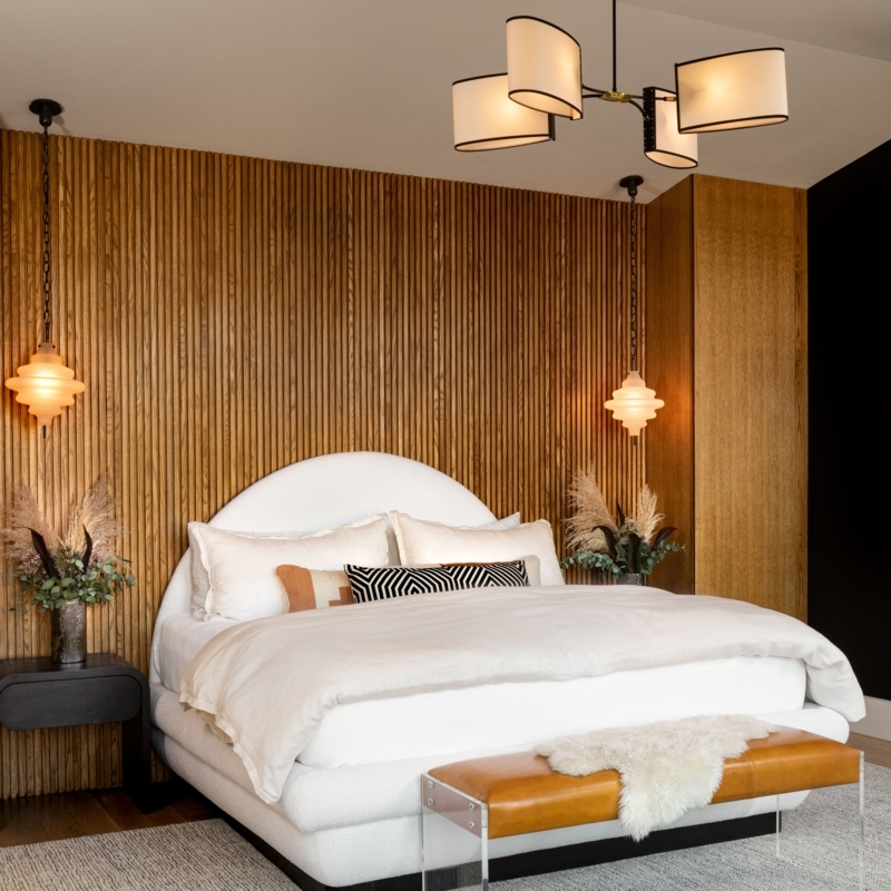 Bed with Arched Headboard against Vertical Wood Slat Accent Wall