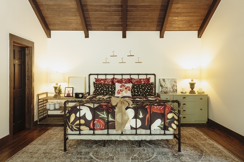 Bed with Black Industrial Pipe Frame and Bold Floral Duvet Cover.