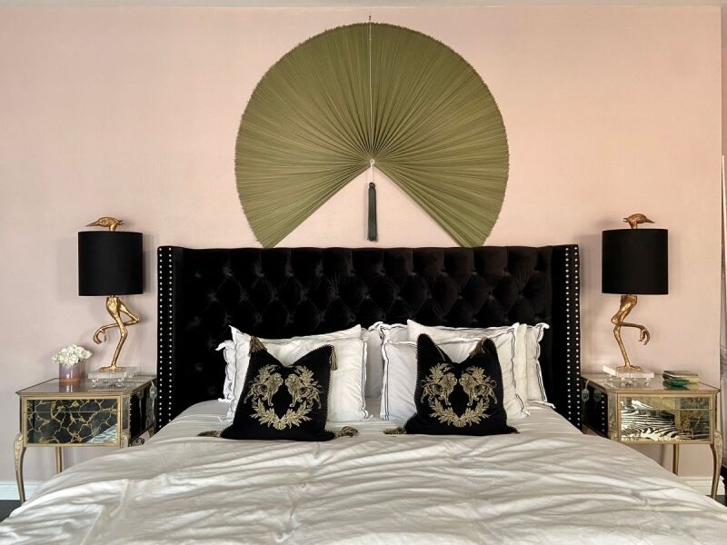 Bed with Black Tufted Velvet Headboard and Gold Flamingo Lamp Decor