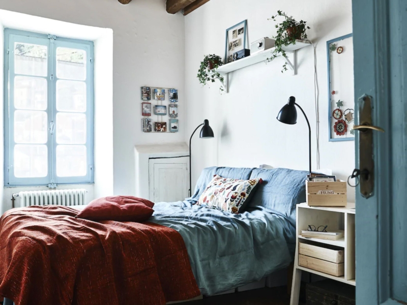 Bed with Blue Linen Bedding and Terracotta Accent in Rustic Bedroom