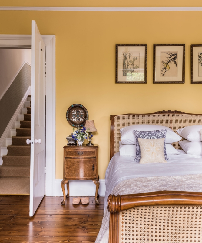 Bed with Cane Inlay in a Room with Mustard Yellow Walls