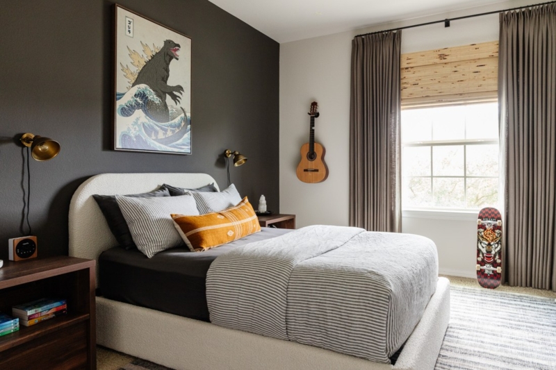 Bed with Curved Upholstered Headboard and Godzilla Wall Art Decor