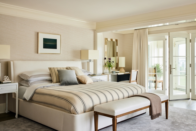 Bed with Horizontal Striped Linens in Airy Bedroom with French Doors