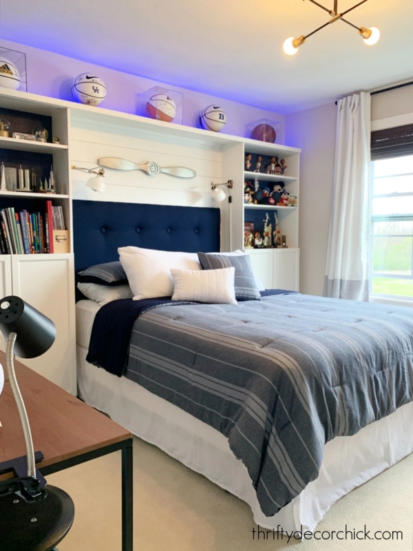 Bed with Navy Tufted Headboard and Built-In Shelving Surround