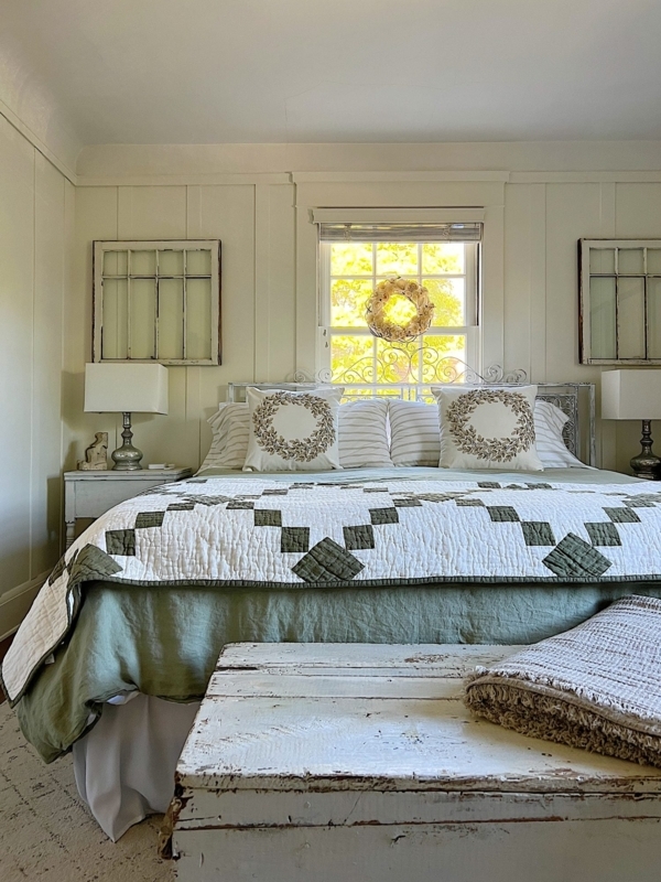 Bed with Sage Green Geometric Quilt and Vintage Window Pane Wall Decor