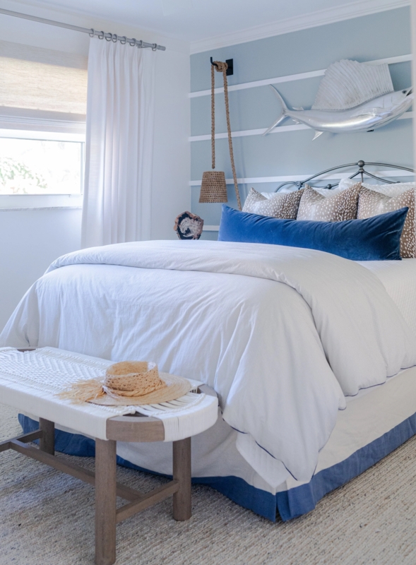 Bed with Silver Sailfish Art and Navy Velvet Lumbar Pillow