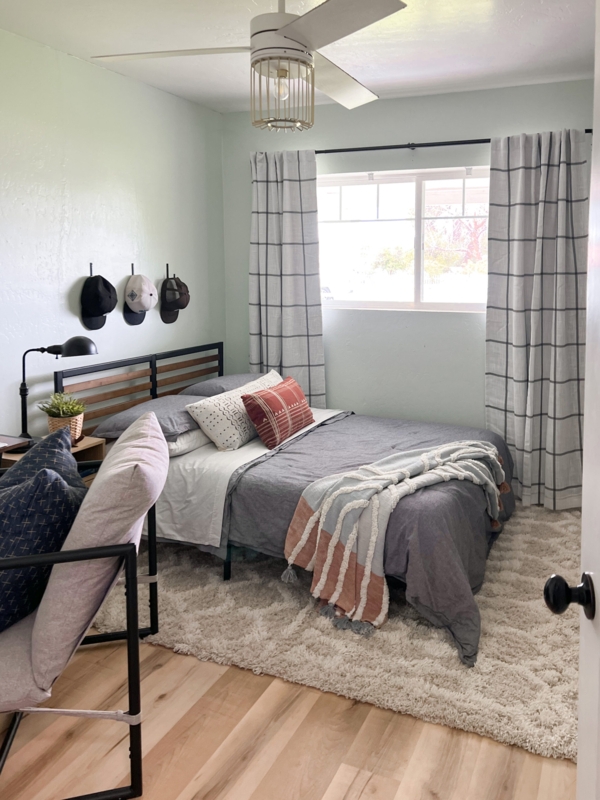 Bed with Slatted Metal Frame in Mint Green Room with Grid Curtains