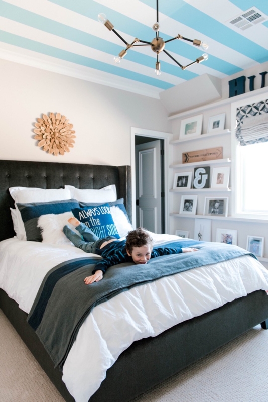 Bed with Tufted Headboard and Bold Striped Ceiling