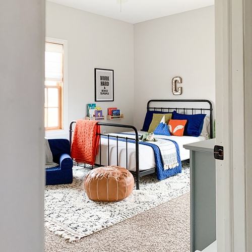 Bed with Woodland Themed Bedding and Black Spindle Frame
