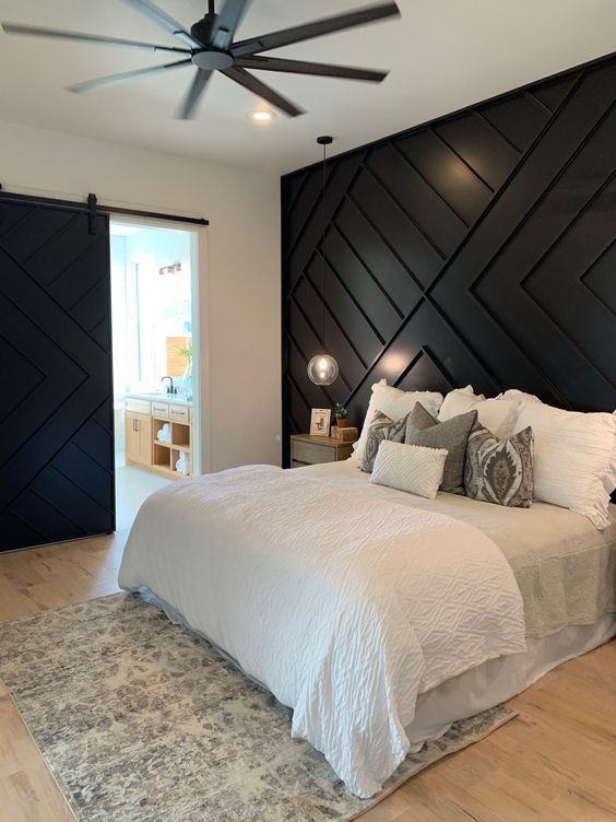 Bedroom Decor with Dramatic Black Geometric Accent Wall and Barn Door